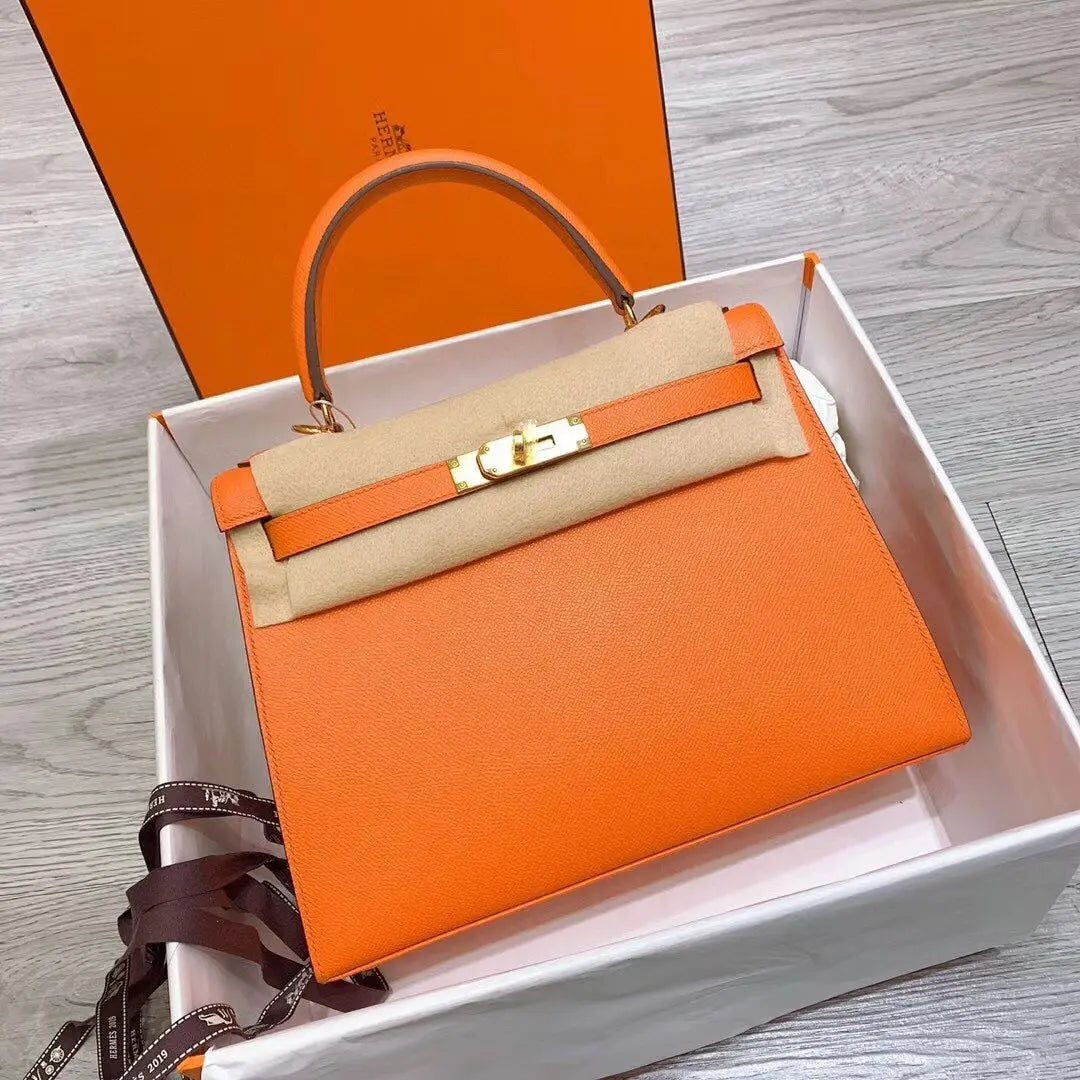 Hermès Kelly Bag in Orange Togo Leather with Gold Hardware Chic Tread